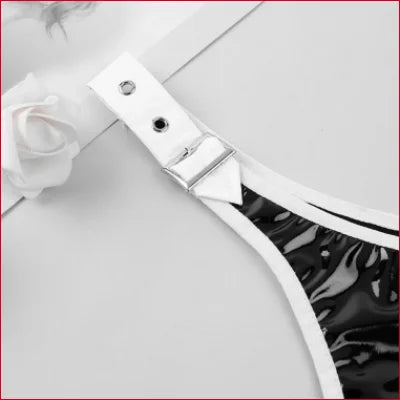 White buckle detail on adjustable black faux leather belt for women showcasing style