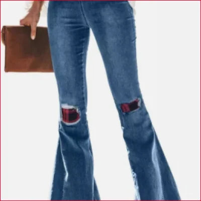 Pair of flared blue jeans with ripped knees and a brown wallet for vintage leopard patchwork look