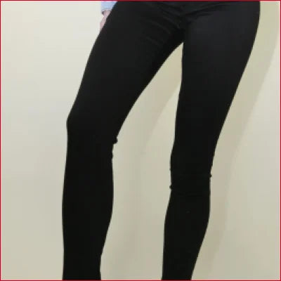 Pair of legs in Classic Black Skinny Jeans featuring Stretch Denim for comfort