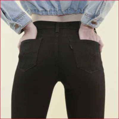 Hands in back pockets of Classic Black Skinny Jeans with Stretch Denim Comfort