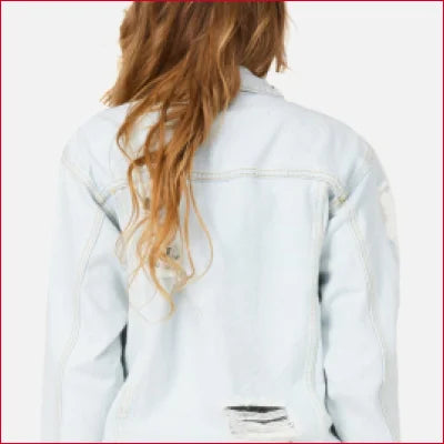 White denim jacket with ripped details and long wavy hair, perfect for all seasons