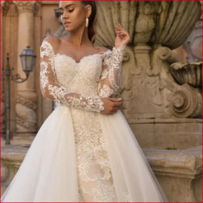 Ornate white wedding gown with lace sleeves and long detachable train for a stunning look