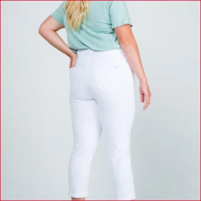 White Capri pants paired with a mint green top showcasing mid rise boyfriend style