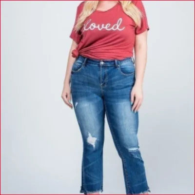 Woman in red loved t-shirt and ankle length distressed Kick Flare Jeans with hem