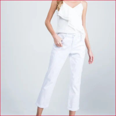 White sleeveless jumpsuit with ruffled top, perfect for styling with boyfriend jeans