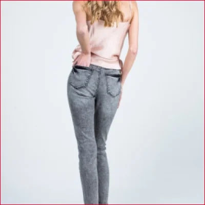 Woman from behind wearing Grey Wash Button Fly Skinny Jeans and a pink top