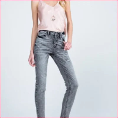 Pair of skinny jeans in grey wash with button fly, styled with a light pink top