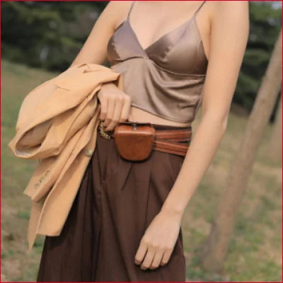 Woman in beige top and brown skirt showcasing a luxurious Mulberry silk bra