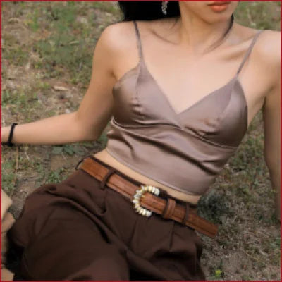 Woman in beige tank top and brown pants showcases luxurious Mulberry Silk Bra