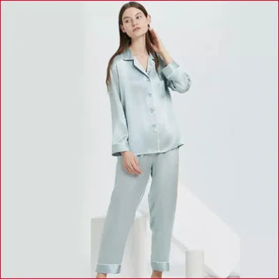 Woman in light blue Eco-Friendly Mulberry Pure Silk pajamas with button-up top