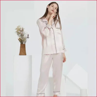 Woman in pale pink Eco-Friendly Mulberry Pure Silk Women’s Pyjamas with contrasting piping