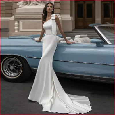 Elegant white one-shoulder wedding dress with sweep train, perfect for bridal elegance