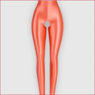 Stylized female lower half in coral pink wearing Open Crotch Glossy Crotchless Leggings