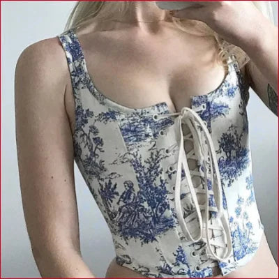 Corset-style top with blue floral pattern and front lacing featuring white flower motifs