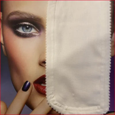 Close-up of a face with white fabric, featuring padded leggings with crotch zipper