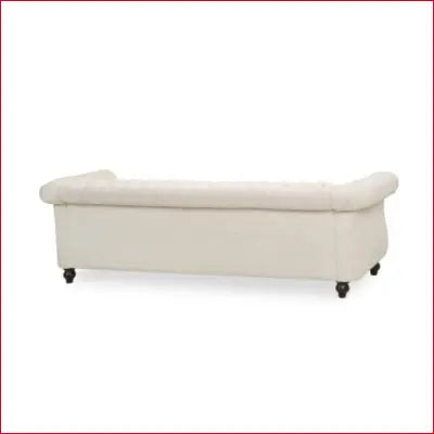 Cream-colored Chesterfield sofa with flared arm and removable cushions in beige