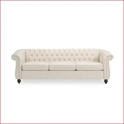 Tufted cream-colored Chesterfield sofa with flared arm and removable cushions design