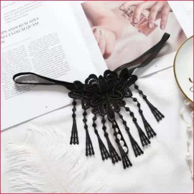 Black lace choker with floral design and beaded tassels for an erotic fashion statement