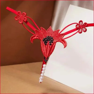 Red decorative tassel with floral elements and beads for Intimate Faux Pearl lingerie