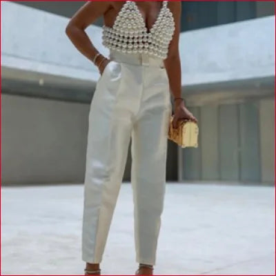 White high-waisted trousers with a faux pearl tank tube top, a trendy Y2K look