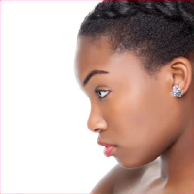 Profile view of a woman with short dark hair wearing sterling silver stud earrings