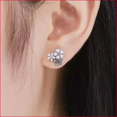 Floral-shaped stud earrings in sterling silver with pink daisies and crystal petals