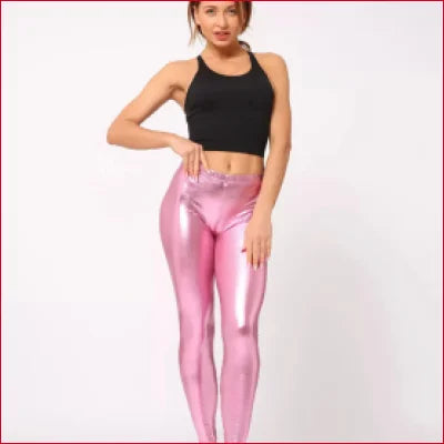 Woman in a black crop top wearing Shiny Pink Disco Pants leggings, stylish and vibrant