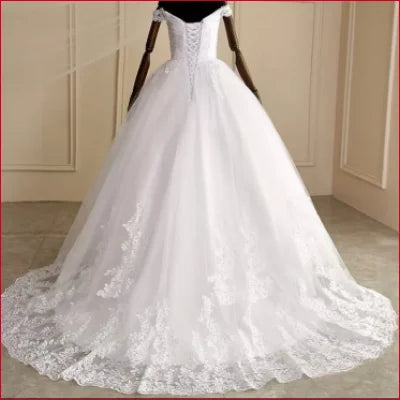 Elegant white princess bridal gown with off-shoulder design and lace-trimmed train