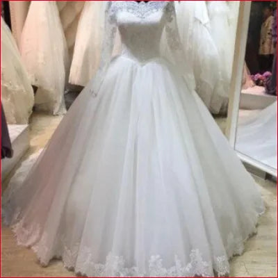 Elegant Princess Wedding Dress with Sleeves featuring a full skirt and lace details