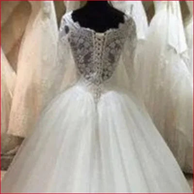 Elegant Princess Wedding Dress in White features a lace bodice and full tulle skirt