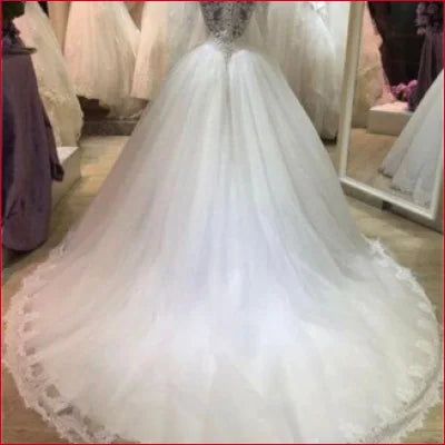 Elegant Princess Wedding Dress with Sleeves in White featuring a voluminous skirt and train