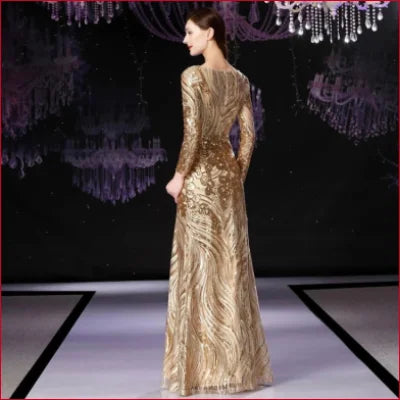 Gold sequinned prom formal evening dress with long sleeves and floor-length skirt