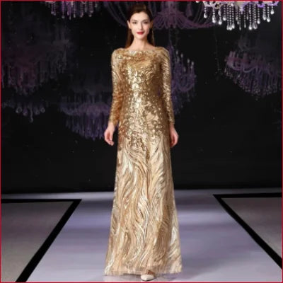 Shimmering gold sequinned prom formal evening dress with long sleeves and flowing skirt