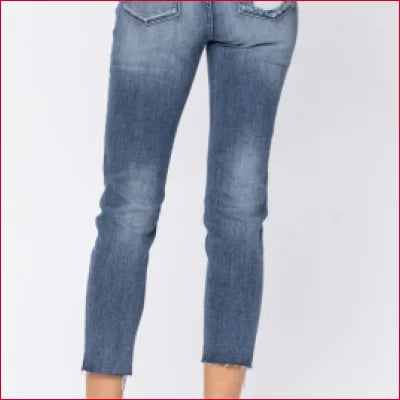 Light blue cropped skinny jeans with frayed hems, featuring a stylish high waist design