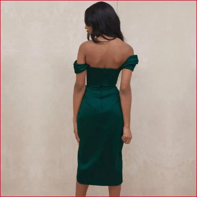 Green satin corset off shoulder bodycon women’s dress worn by a woman facing away