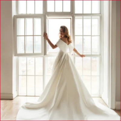 Elegant Satin Off Shoulder Bridal Gown featuring an off-shoulder design and flowing train