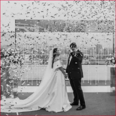 Bride and groom celebrate with confetti in an Elegant Satin Off Shoulder Bridal Gown