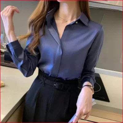 Blue Satin Silk Women’s Blouse paired with a black high-waisted skirt and belt