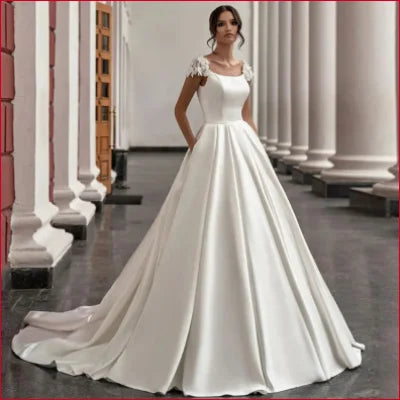 Elegant white wedding dress with cap sleeves, full skirt, and crotch zipper detail