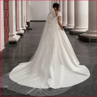 Elegant Satin Wedding Dress with Lace Sleeves and Long Train, featuring a crotch zipper