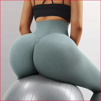 Woman in scrunch butt leggings seated on an exercise ball for a stylish look