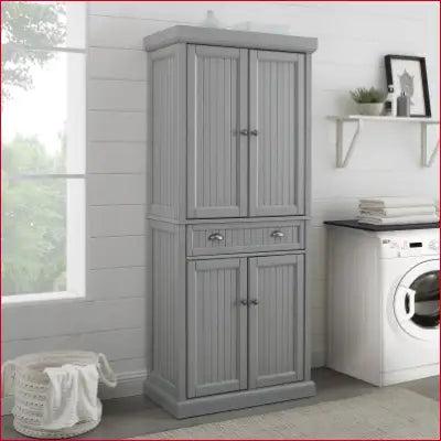 Gray laundry storage cabinet in Seaside Coastal Wood/Metal Pantry, distressed gray finish