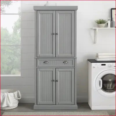 Gray wooden storage cabinet in Seaside Coastal Wood/Metal Pantry with distressed gray finish