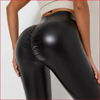 Sexy black leather scrunch butt leggings hugging a woman’s lower body fashionably