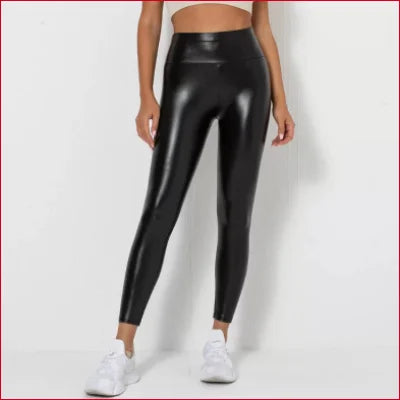 Shiny black high-waisted scrunch butt leggings for women paired with white sneakers