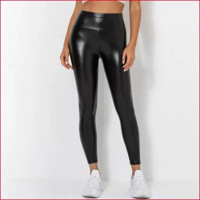 Shiny black high-waisted scrunch butt leggings paired with white sneakers for a sexy look