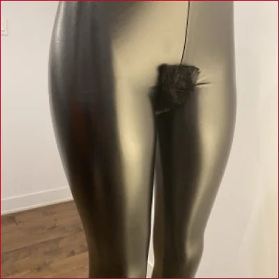 Shiny metallic mannequin legs in dark boots showcasing Vegan Black Leather leggings