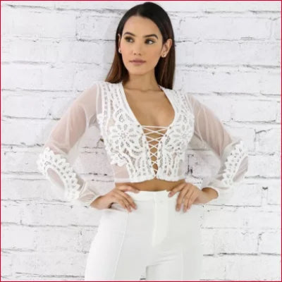 Sheer white crop top with lace long sleeves and plunging neckline for a stylish look