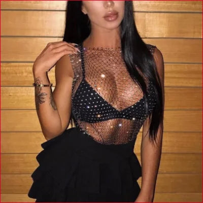 Woman in sheer fishnet tank top with studded bra, perfect for a wedding dress look