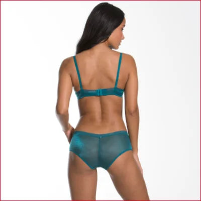 Teal Gossard Glossies Sheer lingerie set with bra and boyshorts on female figure’s back